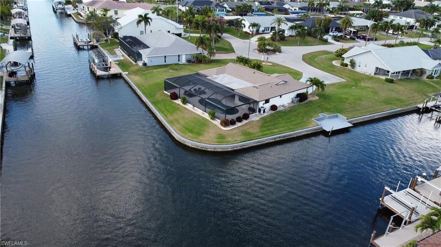 Rare Find, Beautifully Updated 3/2 pool home setting on a Huge, .38ac,  Intersecting Canal, Direct Gulf Access lot,  in SW Cape Coral. Located at the end of the cul-de-sac. All upscale designed (2023), matching Tile throughout, solid wood cabinets w/Quartz counters kitchen & baths, Very nice stainless appliances, split bedrooms, Open floor plan, power inside blinds over High Impact Windows. Impact Sliders take you to the Oversize lanai surrounding the newly updated pool with Travertine deck and new pool cage highlighted by the Panoramic Screens. The Lanai offers plenty of room to entertain, watch TV or just relax. Pool is salt water and features a new heater. This is truly "Move-in-Ready". Take a look, you won't be disappointed!!!