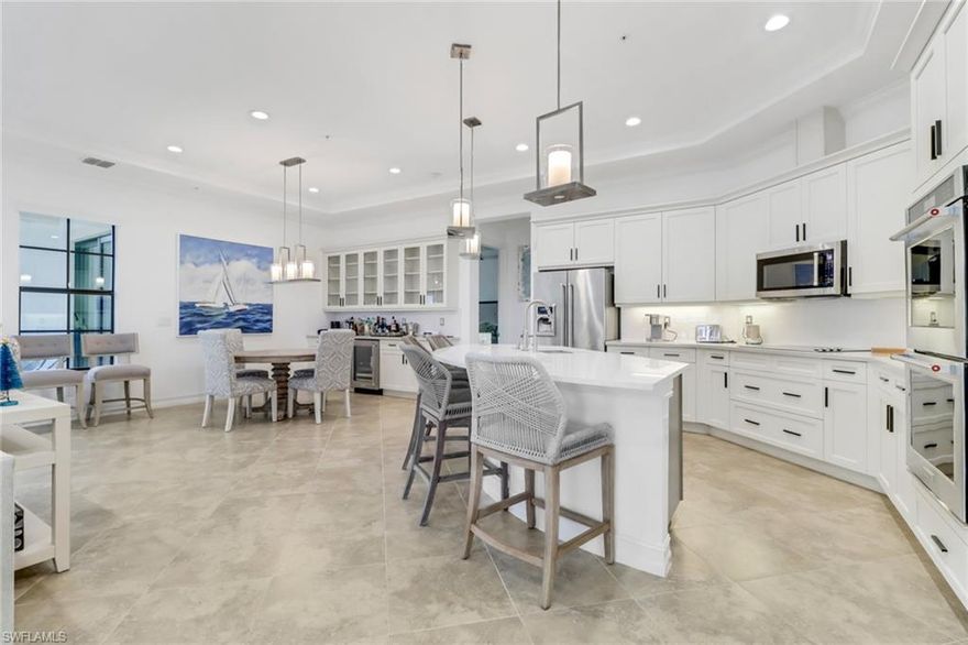 Immerse yourself in Naples paradise at this sought-after open floor plan end unit in Regatta Landing at Windstar. This luxurious coach lives like a single-family home with an attached 2-car garage, enclosed lanai, and breathtaking western vistas of the championship golf course and endless lake view sunsets. Inside, a well-designed layout seamlessly connects the great room to a chef-inspired kitchen boasting stainless steel appliances, quartz counters, and a wine cooler. Exquisite finishes, tray ceilings, and wood/tile flooring throughout elevate the ambience, while the owner's suite beckons with a sitting / workout area, walk-in closets, and a spa-like bathroom. Beyond your doorstep, a world of amenities awaits - boat shuttles to a private beach, sunset cruises, tennis, fitness, sparkling pools, and vibrant downtown Naples just a 3-mile drive away. This small and private section of Windstar features its own pool/spa and cabana, and a separate entry and exit accessing Bayshore Drive. Regatta Landing is the epitome of luxurious living in Naples - don't miss your chance to make it yours!