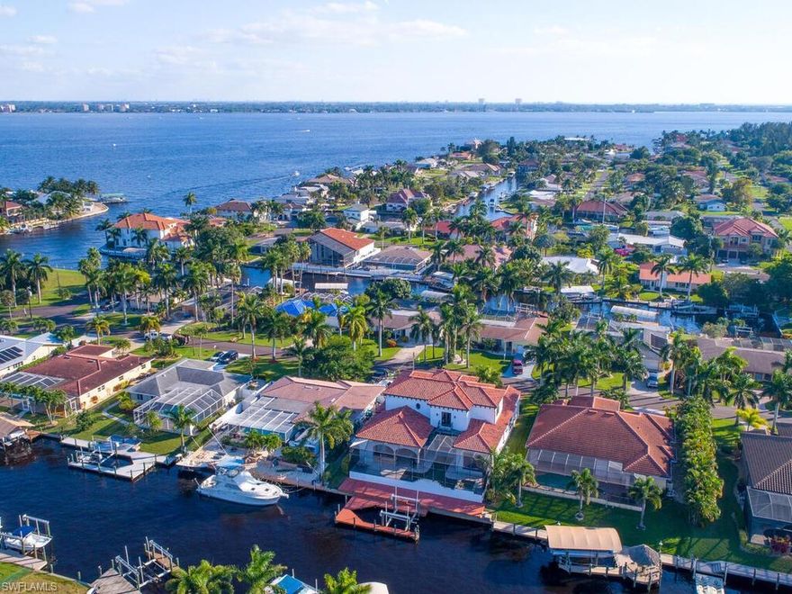 THE VIDEO TOUR AND PICTURES TELL THE STORY OF THIS PREMIUM WATERFRONT LOCATION - DESIRED SOUTHERN REAR EXPOSURE - LESS THAN 5 MINUTES TO RIVER ONLY 30 MINUTES TO THE GULF - UNIQUE MOVE IN READY REMODELED HOME- NEWER POOL PACKAGE WITH SPA , AMAZING NEW PAVER PACKAGE, NEWER DOCK AND CAPTAINS WALK WITH CANOPY, 14,000 LB LIFT AND 32' SLIP. NEW 3RD BEDROOM RECENTLY COMPLETED. Virtual Tour Link and Pictures in this listing tells this Story. This is a dream boating location! Home features include rich quality in design, finishings and selections. Your prime Waterfront- Gulf Access No Bridges– No Lock- Southern Rear Exposure location quest is over! This property would make a wonderful gulf access seasonal retreat , rental property investment or primary home. Home was original late 1960's vintage Cape Coral design. Now an elegant yet simple "Transition Concept Design". Well thought out renovation. Nicely done. Move in ready. Call for a showing soon - you may be glad you did.