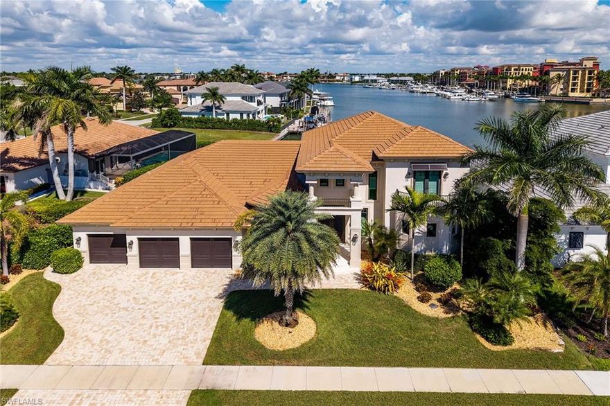 Are you ready to wake up to breathtaking bay views every day and experience true waterfront luxury?
Nestled along the peaceful shores of Smokehouse Bay, this stunning 2018 RK Reiman custom-built home with 3 car garage offers the ultimate in coastal luxury. Spanning 3,829 square feet under air, this 4 bedroom, 4.5 bathroom residence boasts breathtaking views of the bay and The Esplanade.
As you enter through the dramatic two-story foyer, you are immediately greeted by the expansive great room. With its soaring volume ceilings, large open sliders, it offers immediate, unobstructed views of Smokehouse Bay and the stunning yachts lining The Esplanade.  The open-concept design allows the interior to seamlessly flow into the screened lanai, where the pool and spillover spa invite relaxation.
The chef's kitchen is a true standout, featuring a large island, double wall ovens, a custom backsplash, and a spacious walk-in pantry for ample storage.
The luxurious primary suite offers direct access to the lanai through elegant french doors. Enjoy views of the tranquil bay and the spillover spa, enhancing the seamless connection between the indoors and outdoors. The ensuite bath, complete with dual vanities, a soaking tub, a walk-in shower, and a hidden walk-in storage area cleverly tucked within one of the primary bath cabinets for added convenience and organization.
On the first floor, the primary bedroom is complemented by a guest bedroom, with a bath that also serves as a pool bath, creating a perfect split floor plan. The dedicated study, with French doors leading to the main living area, offers a peaceful space for work or relaxation.
The 2nd floor features two ensuite bedrooms, each with private baths, along with a common area that leads to a balcony offering raised, unobstructed views of the bay and beyond. 
Throughout the home, custom finishes abound, from textured walls in the great room and half bath to the carefully selected materials that enhance the home’s unique style. The great room features the Whispered Elegance wall finish, while the powder room boasts the luxurious Lido finish. Custom ceiling details grace each room, adding a unique and refined touch throughout the home. 
Other Features Include:  A whole-home generator with a 1,000 lb propane tank which also fuels the gas range and outdoor kitchen grill,  whole home water filtration system, impact windows and doors, electric shutters on the lanai, security system, safe, central vacuum system that’s only 3 years old, double 2.5-year-old hot water heaters, dedicated storage closet on the lanai, and a low, transferable flood policy.
For boating enthusiasts, this home is a true gem. A newer seawall, coupled with a beautiful dock and boat lift, offers quick access to the Gulf.  
With its perfect blend of luxury, comfort, and coastal charm, this home presents an extraordinary opportunity to experience Marco Island living at its finest.