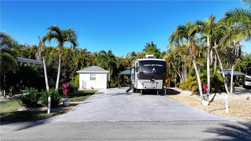 Welcome to Lot C126, an oversized and beautifully landscaped RV lot located in the highly sought-after Cypress Woods RV Resort. Offering approximately 4,783 square feet, this spacious property combines privacy, tropical curb appeal, and quality upgrades—ideal for seasonal or full-time RV living.
The lot features a thoughtfully designed landscape plan with a variety of mature tropical palms, lush foliage, grass accents, and decorative rock elements that create a polished and low-maintenance outdoor environment. A dense wall of Areca palms lines the rear of the property, providing exceptional privacy and a tranquil setting.
A 12x16 hardtop gazebo sits on an elevated concrete slab, offering a stable and inviting space for outdoor dining, entertaining, or relaxing in the shade.
The accessory building has been recently fully remodeled and is move-in ready, complete with a washer and dryer, toilet, sink, television, and upgraded mini-split air conditioning system. Modern finishes and improvements enhance both comfort and functionality.
This well-maintained, oversized lot presents an excellent opportunity to enjoy resort-style RV living in a gated community with outstanding amenities and a prime Fort Myers location.
