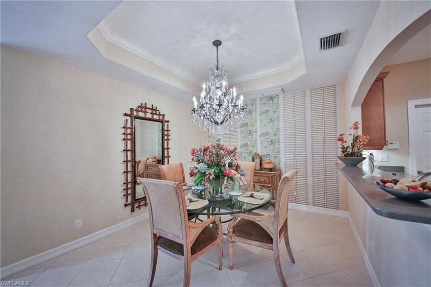 wow! Nice reduction!!! A luxurious life at Tiburon, the Royal Palm entry sets the tone for this stunning 1st floor end unit 2 bedroom with a den hardly lived in, still looks new. You will be amazed with the detail to design. Professionally designed with so many features, a few are custom wall and window coverings beautiful Chandeliers, Gas range, custom cabinets in the kitchen, crown molding just to name a few.  Sold Turn Key furnished for this lovely home, with golf course views. Not mention great schools, and all the dinning and shopping features of North Naples.  No mandatory golf for this unit
