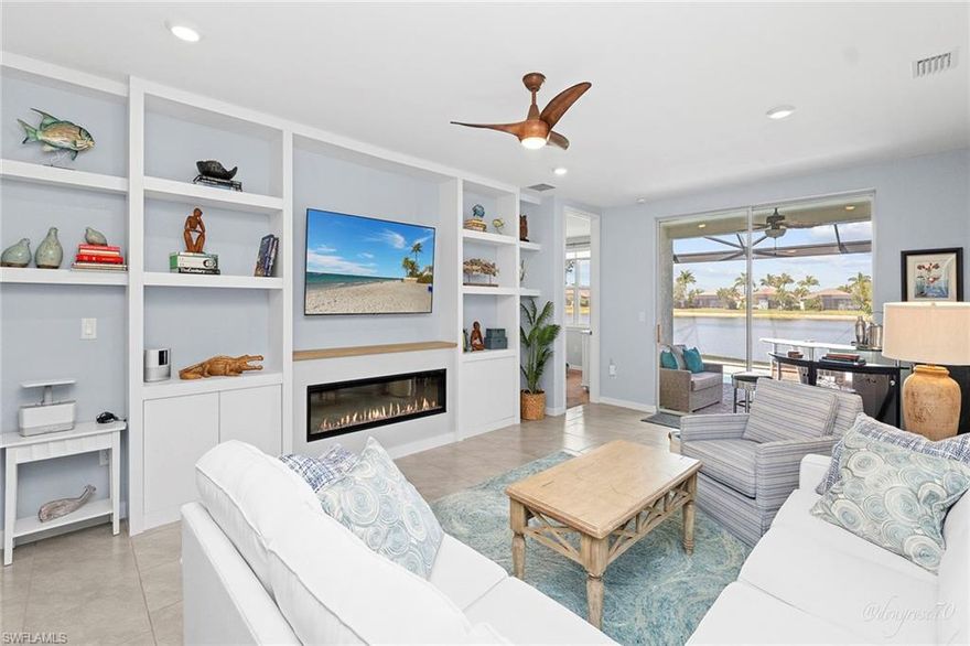 Expansive water views set the stage for this private expression of coastal luxury, where thoughtful upgrades and a relaxed elegance create an effortless indoor-outdoor lifestyle. Light fills the open interior, where two bedrooms, two full baths and a versatile den offer flexibility for guests, work or quiet retreat. The layout feels welcoming and refined, complemented by a two-car garage with epoxy flooring and tasteful design details throughout. The living space is anchored by a custom fireplace feature wall, while staggered tile flooring and quartz countertops lend a cohesive, modern aesthetic. In the primary bath, a frameless glass shower with tile extending to the ceiling adds a spa-inspired finish, creating a serene space to unwind at end of the day. Outdoor living is equally inviting. A heated saltwater pool overlooks tranquil water views, offering a peaceful backdrop for morning swims, leisurely afternoons and intimate evenings. A picture-frame screen and Florida glass provide privacy and uninterrupted sightlines, enhancing the sense of seclusion and calm. Immerse yourself in resort-style living with a wealth of community amenities. Enjoy 22 serene lakes, a mile-long rowing lane, a boat ramp, an island club and a fitness center. Unwind at the bocce courts, beach volleyball court, tiki bar, or café offering food and beverage service. The resort-style pool with lap lanes, a fire pit and a private Kon-Tiki island complete the picture of luxury. Outdoor activities abound with stand-up paddleboards, kayaks, bicycles, tennis and pickleball courts, two dog parks, and extensive biking and recreational paths. Families will love the basketball court and Kid's Cove playground. Conveniently between 5th Avenue and Marco Island, this home offers easy access to premier shopping, dining and stunning beaches. Your dream home awaits so schedule your tour today!