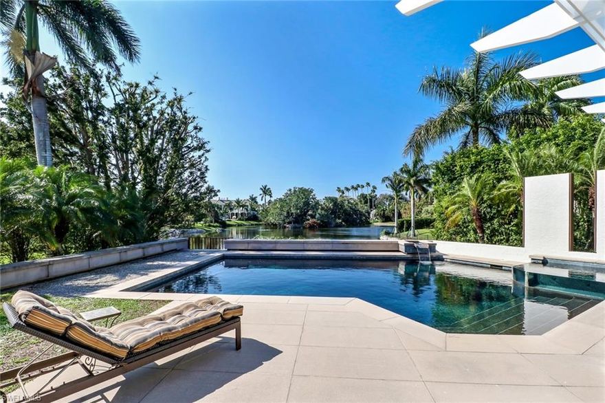 Mature trees and skillfully landscaped grounds surround this 2-story sun-filled home carefully crafted by renowned architect, Kasimir Korybut.  A double door entry invites you through the zen courtyard and into this charming home. The main level includes a spacious living / dining room, two en-suite bedrooms with lake views, half bath and custom kitchen.  Ideal for formal or casual entertaining the open kitchen includes 2 wall ovens, 2 dishwashers, wet bar, wine cooler, endless storage and butler pantry.  Up the spiral staircase, the entire 2nd floor consists of a spacious owner's suite, boasting sliders that open to a private balcony.  Downstairs, the floor-to-ceiling sliders open to extend your living to the outdoors.  Entertain and lounge the day away with captivating wildlife views from your luxurious salt water pool / spa,  outdoor shower and kitchen.  As evening approaches, indulge in a bottle of wine as you watch the colorful sunset dance over the sparkling waters of Half Moon Lake.  Air-conditioned garage with storage. Updates include new: exterior paint, water heater, water filtration system, and sprinkler system. Just a short walk to the beach, fitness, tennis and club.