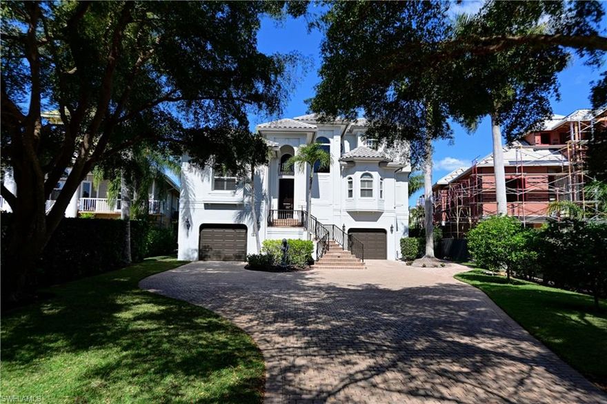 Incredible 4 bedroom, plus den, 4 bath home located in the gated community of Bayfront Gardens within Barefoot Beach.  Features two story living room w/fireplace & outdoor deck overlooking the pool/bay. The kitchen offers breakfast bar, granite counters, custom cabinetry & high quality appliances.  Main floor also features formal dining, office/den & 2 guest suites. 3rd floor includes the grand master suite w/large master bath, marble floors & counters, separate his/her vanities & closets.  Adjacent to the kitchen is a family room & guest suite. Backyard features pool, spa and is totally fenced. Property also includes boat dock with lift & offers quick easy access to the Gulf.  Walk right across the street to the beach via dedicated beach access.