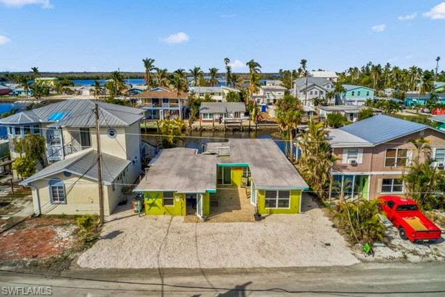 Rare opportunity in the heart of the Matlacha Historic District—a beautifully renovated waterfront duplex uniquely configured with five bedrooms, five bathrooms, and individual efficiency-style kitchenettes. While officially classified as a duplex, the interior layout offers exceptional flexibility: each bedroom suite functions as an independent studio-style unit, creating an attractive income-producing property with five rentable studios.

The building has been freshly updated throughout, and the furnishings and interior décor are nearly brand new. Guests and tenants enjoy ample on-site parking and a wind-protected central courtyard that adds privacy and charm.

Located directly on open saltwater with immediate boating access, the property features a double boat dock and generous outdoor seating areas overlooking the water. Positioned perfectly on the sunset-facing side, the dock and rear terrace capture breathtaking Florida sunsets that define the Matlacha lifestyle.

This is a truly exceptional location—right in the center of Matlacha’s Historic District, walkable to shops, art galleries, restaurants, and waterfront attractions. Properties with this combination of charm, income strength, and direct water access rarely come to market.

Ideal for investors seeking a proven revenue property, or for buyers wanting a flexible-use waterfront home with built-in income potential. A standout opportunity in one of Southwest Florida’s most iconic and sought-after waterfront communities.