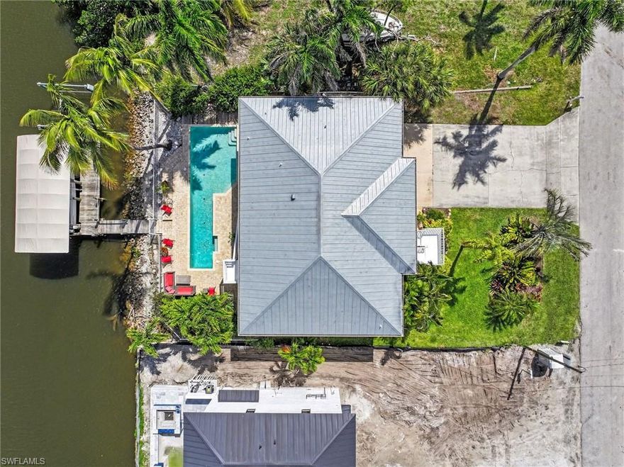 This stylish 'Old Florida' waterfront home offers so much more than meets the eye! The view of the 100’ Wide Canal is sensational from the lengthy, screened Lanai, which also overlooks the Lap Pool and 2 Docks! With vaulted ceilings and 1,546 sq. ft. of living area upstairs the 3-bedroom split plan will work great for your future guests. The lower 2-car garage has a workshop and lots of storage! The residence's extended drive allows parking for your various vehicles without limit. The 75 ft. wide lot offers plenty of flexibility. One can fish off the dock or hop on their boat or jet ski and be in the Gulf in 20 minutes! Complete with a metal roof the home is in great condition and the elevated lot helps keep the living quarters high and dry should the need arise. Now is your chance to start 'LIVING THE DREAM' and build a lifetime of memories! Check out this marvelous value soon!