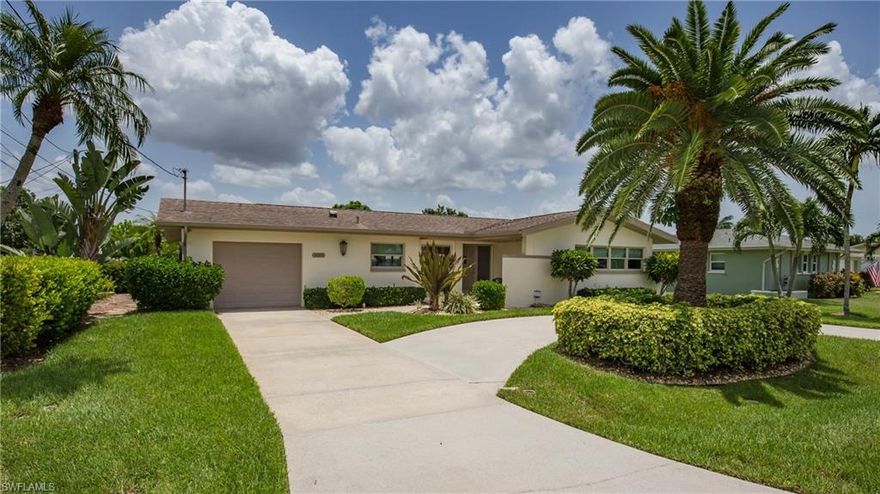 GULF ACCESS, SAILBOAT ACCESSIBLE, SHORT RIDE TO THE RIVER, FULLY REMODELED SPLIT PLAN HOME!  Kitchen features breakfast bar, premium granite counters and backsplash, beautiful cabinets, and high-end stainless appliances. Custom Hunter Douglas window treatments throughout the home. The travertine floors though the main part of the home extend to the front porch and lanai. Master suite features a walk-in closet and updated bath. The canal view from the lanai is framed by a private lush landscaped lawn. The composite captains walk, covered 10,000 lb boat lift, and tiki bar cap off the rear yard view. The circular drive provides significant off street parking. This is a must see move in ready home.