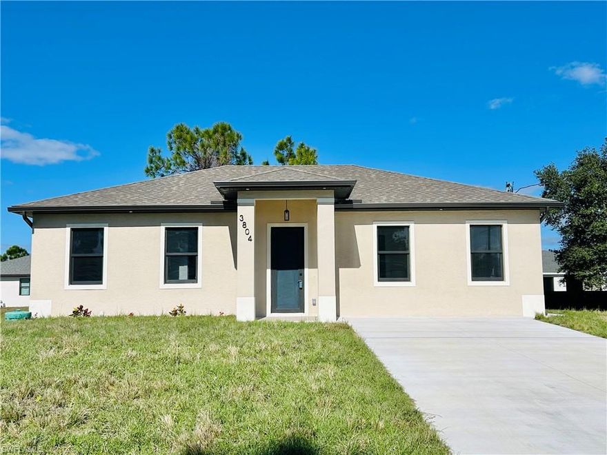 Great location in SW Lehigh close to Gunnery. Price perfectly set to sell! Don’t miss this incredible opportunity to own a beautiful, modern, and cozy single-family home with a fully private efficiency studio, complete with its own kitchenette and separate private entrance, offering true income-producing potential and a rare multigenerational living setup in the heart of Lehigh Acres. This move-in-ready gem features 4 bedrooms and 3 full bathrooms with a flexible layout that allows you to live in the main home while renting out the studio, or enjoy the entire space for extended family. Loaded with upgrades, the home showcases wood-style ceramic plank flooring, white quartz countertops with a stunning waterfall-edge island bar for extra seating and wine cabinet, modern backsplash, impact windows and smoked hurricane-impact glass doors, luxury spa-style shower systems with built-in shower niches, LED lighting, tankless water heater, large baseboards, ceiling fans with LED lights, elegant trim details, a wine cabinet, fresh sod, and a clean inviting backyard. The long double driveway provides excellent extra parking for approx 6 cars, making this almost a duplex-style investment without the duplex price tag. Located near Gunnery Rd, restaurants, shops, parks, and more, this property offers unbeatable style, comfort, and investment potential all in one. This one won’t last, schedule your showing today and come see why this home is the best deal in town! (No garage, but the extended double driveway offers ample parking.)