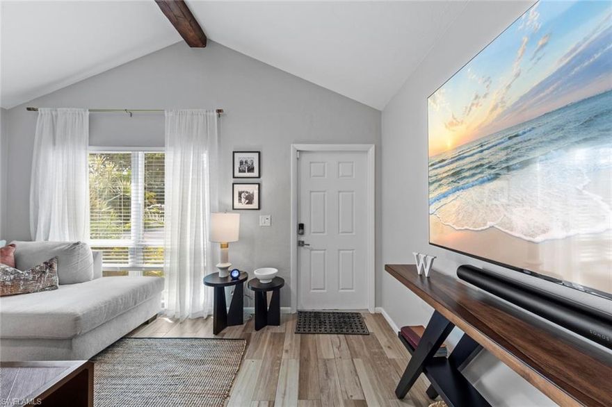 Stylish renovation meets serene waterfront living in this beautifully updated North Naples residence, ideally positioned in Splinterwood at Palm River. Offering 2 bedrooms plus a versatile den and 2 full baths, this move-in ready home blends modern design with a peaceful, private setting. Enjoy tranquil canal views with expansive green space beyond, creating a natural backdrop that enhances both privacy and everyday living. Eastern rear exposure welcomes soft morning light—perfect for enjoying quiet sunrises from your outdoor space. Inside, a full renovation showcases a clean, contemporary aesthetic with seamless flooring throughout for a cohesive flow. The updated kitchen features stainless steel appliances, a glass cooktop, built-in oven, and modern finishes designed for both function and style. Vaulted ceilings accented with rich wood beam details add warmth and architectural character, while the flexible den offers the ideal space for a home office, guest room, or additional living area. Located in the highly desirable Palm River community, just minutes from top-rated schools, shopping, dining, and everyday conveniences, and a short drive to Naples’ pristine Gulf beaches—offering the perfect balance of comfort, design, and location.