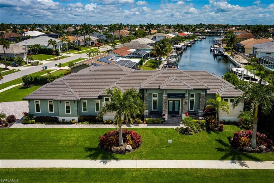 Discover the pinnacle of coastal luxury in this 2024-built masterpiece on Marco Island. Situated on an oversized corner lot, this residence offers sweeping water views from nearly every room. The interior boasts premium Travertine flooring, custom wood ceiling details, and a gourmet kitchen featuring Sub-Zero and Wolf appliances. Seamlessly transition to outdoor living through floor-to-ceiling glass sliders into a screened lanai, complete with a custom heated pool and spa. Outdoor living is elevated by a $15,000 outdoor kitchen enhancement package provided by the owner. The lanai is already plumb-ready, allowing you to select the finishes for your ideal waterfront entertaining area. See quote and optional layout in pictures. For boating enthusiasts, the private dock includes a 30-foot slip and double jet ski lift with direct canal access. High-end upgrades include a whole-home Generac generator, impact glass, and an epoxy-finished 3-car garage. A true sanctuary for the discerning buyer.