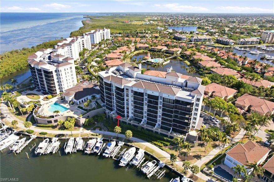 Welcome to waterfront living in Grande Isle Towers. This beautifully maintained, turnkey 3-bedroom, 3-bath residence designed to capture sweeping views of Charlotte Harbor. Perfectly positioned on the first floor, this exceptional residence features both a screened lanai and an expansive open-air balcony. Inside, the home opens to a bright and spacious open-concept living, dining, and kitchen area. The kitchen is highlighted with elegant quartz countertops and matching white subway tile backsplash. The large island offers generous prep space and casual seating. It is well-appointed with stainless steel appliances, including a built-in microwave and range. Two-tone cabinetry enhances the design, pairing white upper cabinets—some with glass-front displays—with darker lower cabinetry for added depth, style, and storage.  The dining and living areas flow seamlessly from the kitchen, creating a cohesive, airy layout ideal for both relaxing and entertaining. A convenient wet bar with a built-in wine cooler enhances the space, making it perfect for hosting and everyday enjoyment. Neutral tile flooring runs throughout, complemented by soft coastal tones that reinforce the relaxed waterfront ambiance. Large sliding glass doors fill the living area with natural light and open to the lanai and balcony, extending the living space outdoors. The spacious primary suite features direct access to the lanai, stunning water views, oversized walk-in closets, and a luxurious ensuite bath complete with a soaking tub, dual sinks, and a walk-in shower. Guests will appreciate the desirable split-bedroom layout, which includes two additional bedrooms—one of which is ensuite for added privacy. Peace of mind is ensured with impact-resistant hurricane windows and sliders, along with a prime location in Flood Zone X due to the building’s elevated position within the marina. Additional upgrades include plantation shutters, custom blinds, coastal furnishings and décor, French doors, a new dishwasher, assigned under-building parking, and an indoor laundry room with cabinetry and sink. The gated under-building garage offers kayak, golf cart, and bicycle storage, along with a private storage closet for all your beach, golf, and boating essentials. Residents of Grande Isle enjoy access to an exceptional clubhouse featuring an Olympic-size heated pool and spa, grilling area, elegant social room with catering kitchen, bar & billiards, fitness center, private theater, steam room, and dry sauna. Burnt Store Marina offers an unmatched waterfront lifestyle, anchored by the largest deep-water marina in Southwest Florida with boat storage, slips, and ramp access. Additional amenities include 3 on-site restaurants with live music & events, yacht & country clubs, social & fishing clubs, Freedom Boat Club, bocce, tennis and pickleball courts, a second fitness center, and a 27-hole executive golf course.  **PLEASE ENJOY THE 3D INTERACTIVE VIRTUAL TOUR ASSOCIATED WITH THIS LISTING**