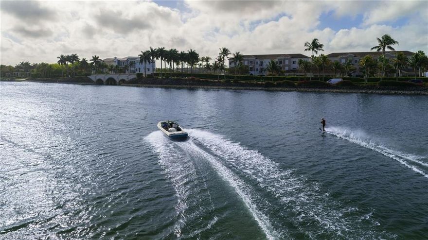 Experience resort-style living in this recently renovated custom coach home perfectly positioned on a beautiful white sand beach overlooking 700 acres of freshwater lake, ideal for boating, water skiing, and fishing. The home has been thoughtfully updated and features a newer HVAC system for comfort and efficiency. Step outside to the spacious lanai that features outdoor kitchen with gas grill, perfect for entertaining while enjoying the breathtaking waterfront setting. The spacious garage with epoxy flooring provides a clean, durable finish and plenty of storage. Located within a prestigious gated community known for its world-class amenities and private beach lifestyle, this stunning coach home offers the perfect blend of luxury, comfort and waterfront recreation.  Miromar features 700 acres of fresh-water lakes, with boating, fishing, swimming, water skiing, 3 miles of sand beaches, Caribbean style beach grill, club house, full-service country club for evening dinning, pool, full-service spa, fitness center, golf, tennis, pickleball, volleyball, basketball, bocce, two marinas, boat rentals and many other luxurious amenities