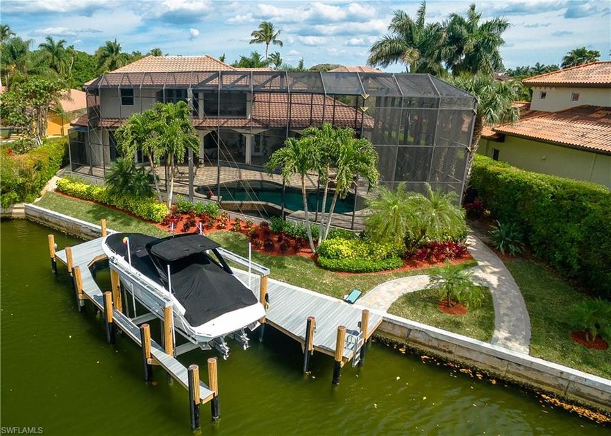 An entertainers delight, this beautiful waterfront home sits on one of the largest lots in Park Shore. With more than 130 feet of water frontage overlooking Venetian Bay and a brand new dock and lift this home is ready to be your gateway to days on the Gulf. This custom property was built with indoor outdoor living in mind. When the sliding glass doors are retracted it expands the main floor living space to the large lanai.  On the screened lanai discover the infinity edge pool with sunning deck and attached spa. On the second level find two guest suites, media room with kitchenette and a large balcony. The spacious garage can handle 5 vehicles. This beautiful home is a short distance to Waterside Shops, Venetian Village and some of the finest beaches of Naples.