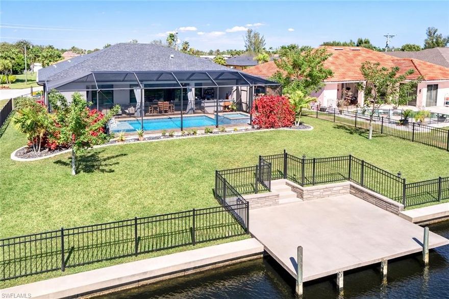 2023 CUSTOM BUILD ON A CANAL WITH A DOCK – POOL & SPA – 3-CAR GARAGE – IMPACT WINDOWS & DOORS – NOT IN A FLOOD ZONE! Beautifully constructed and energy-efficient, this custom-built Southeast Cape Coral home is loaded with high-end upgrades throughout. Featuring 3 bedrooms plus a spacious den and 3 full bathrooms, the property showcases EXCEPTIONAL FINISHES and superior craftsmanship. Enjoy true Florida living with a volleyball-style CUSTOM SALTWATER POOL AND SPA, screened lanai, and a FULLY EQUIPPED OUTDOOR KITCHEN with bar seating — perfect for entertaining. The FULLY FENCED backyard oasis sits on a wide FRESHWATER CANAL WITH SEAWALL AND CONCRETE DOCK, ideal for paddleboarding and enjoying Cape Coral’s expansive canal and lake system. The 3-car garage includes a pavered driveway and ample room for additional storage.
Inside, discover 10–12 ft tray ceilings, tile flooring throughout main living areas, and a FULL SLIDER WALL opening to the lanai with CUSTOM ELECTRIC SHADES for seamless indoor-outdoor living. The gourmet kitchen features an expansive 12-FOOT GRANITE ISLAND, Samsung appliances, INDUCTION COOKTOP, touchscreen refrigerator, GRANITE COMPOSITE SINK with SMART FAUCET, and a spacious pantry. Smart lighting, smart fans, and a Nest thermostat enhance modern comfort. The primary suite offers lanai access, a LARGE WALK-IN CLOSET, dual vanities, and a his-and-hers glass-enclosed shower with river rock flooring and smart toilet. A private office/den with French doors, a guest bedroom with Murphy bed, and a third bedroom with en-suite POOL BATH provide flexible living options.Additional highlights include plantation shutters, IMPACT GLASS with mirrored exterior finish for privacy, spray-foam insulation for energy efficiency, IN-GROUND IRRIGATION, 80-foot Calusia hedges, whole-home GENERATOR HOOKUP, CITY WATER with ALL ASSESSMENTS PAID, and NO FLOOD ZONE designation with NO FLOODING HISTORY. Conveniently located near shopping, dining, schools, and everyday essentials, this is upgraded canal-front living at its finest. Schedule your showing today! THIS PROPERTY QUALIFIES FOR A 1% LENDER INCENTIVE IF USING PREFERRED LENDER, INQUIRE FOR MORE DETAILS. Renderings showcasing furniture have been virtually staged.