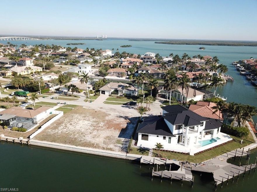 Marco Island Key Lot on premier street with 5 newer large homes.  New  117' seawall-July, 2023.  Recent survey completed and sewer assessment is paid.  Take advantage of approximate 10K impact fee credit.
