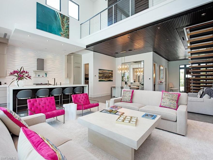 Inviting custom home with traditional and contemporary touches built in 2015. Four bedrooms, 3 full baths and a powder bath in 3,562 square feet under air. Architectural elements include a stacked stone feature wall and cantilevered steel-and-wood staircase draw the eye from the circular drive, through the front door, into the foyer, across the two-story great room, out to an expansive lanai and beyond to the 45’, gas-heated pool and separate spa. Porcelain tile and Ipe flooring, brilliant color palette, tongue and groove ceiling detail, designer lighting, fans and fixtures, metal roof. Perfectly planned kitchen with quartz countertops, island, gas range, wine cooler, very functional butler’s pantry plus formal and informal dining. The first-floor master suite offers a spa-like bath, custom closet and private access to the lanai, gardens and pool. Outdoor spaces are designed for large gatherings or private conversations. Balcony decks are accessible from each second-floor bedroom, plus a covered veranda, accessed through magnificent sliding doors, protects multiple seating areas, dining space and built-in gas grill near the pool. Close to all amenities. Three blocks from the beach.