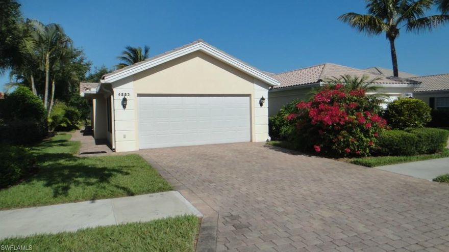 Located in the gated community of Island Walk, this immaculate, well maintained 2 bedroom, 2 bath Villa with attached 2 car garage features an open floor plan, vaulted ceilings, screened patio, oversized side yard with lush landscaping and tranquil lakefront vistas.  Island Walk is home to an exclusive Town Center, complete with restaurant, post office, bank, gas station, car wash, fitness center, beauty salon, two community pools, tennis courts and even a putting green.  Some of this lowest HOA fees in Naples and no CDD.