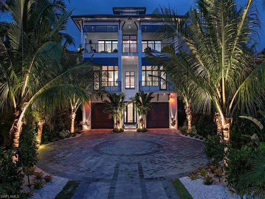 Rare opportunity to obtain a Bonita Beach gated residence that offers both wide Gulf views & wide bay views. Have it all! Walk across the street to the beach or out your back door to your boats and jet skis. This Kriss Lecocq designer furnished home offering a high end modern coastal decor with an expansive open floorplan. Celebrity Chef designed kitchen, large great room w/fireplace, wetbar w/wine display wall & dining that opens to a covered lanai w/ summer kitchen, fireplace, TV, electric screens & shutters, all over looking the wide bay views & negative edge pool & spa with cascading waterfall feature to lower level. The large top floor family room features a custom sea glass top lighted bar, full prep sink, dual refrigeration, HDTV, fireplace and tropical views of the Gulf and sunset. The bayside master is placed for views down the waterway & offers a private terrace with 180 degree water views. Master bath offers a grand glassed shower & soaking tub. 3 VIP guest suites w/ baths. Beautiful oak plank flooring throughout, incredible finishes throughout, private elevator. Large 4 car plus garage. Rare multiple docks and seawall, rear yard entertaining w/ rectangular gazebo.