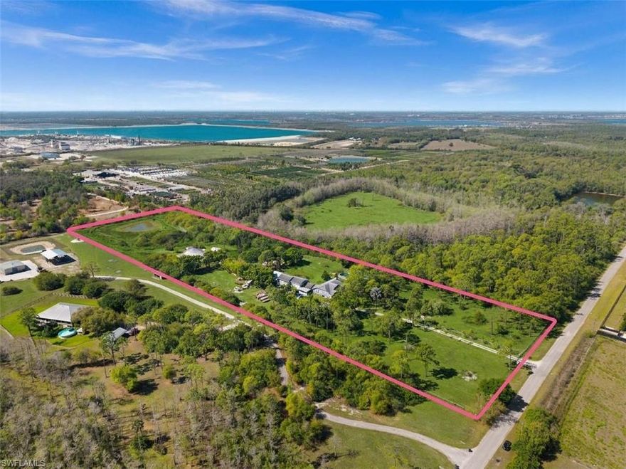 Welcome to a truly rare 10-acre estate - zoned Agricultural (AG-2) with Single Family Residential and Equestrian use - offering an unparalleled combination of privacy, space, and versatility just 5 miles from RSW International Airport.
Through the private gated entrance on North Mallard Lane - a paved private road where your property line extends to the street's centerline - you will find a fully developed compound of multiple buildings, equestrian facilities, and open pasture - no wetlands and no flood zone (Zone X). Approximately 5 acres are additionally buildable, offering meaningful room to expand or develop further.
The main residence is a 2-story Colonial-style home built in 2008, totaling 5,385 sq ft of living area with 9 bedrooms and 7 bathrooms including adjacent buildings. The front structure is wood-framed; all other buildings on the property are constructed of AAC block - one of the most energy-efficient building materials available. Current monthly utility costs only run approximately $300 for the entire 5,385 sq ft. The home includes a wood-burning fireplace, screened covered porch, multiple open patios, finished garage, and finished upper story, all connected through the interior. An outdoor pool and separate guest quarters provide flexible accommodation for extended family, caretakers, or rental income.
Nestled above the barn is a charming wood house imported from Germany - a self-contained space with an additional bedroom and bath, also built with AAC block construction.
The EQUESTRIAN infrastructure is built for serious horse owners. A 3,780 sq ft metal barn and a 2,160 sq ft finished wood barn/stable accommodate up to 10 horses, complemented by a dedicated riding arena and round pen for training. A 760 sq ft pole shed completes the agricultural support structures.
The former airplane hangar - a Quonset-style metal structure measuring 50 x 100 ft (5,000 sq ft) - functions as an oversized workshop or equipment bay, ideal for farm machinery, recreational vehicles, or boats.
Two natural ponds enhance the landscape: one visible from the rear of the main residence, a second in the back pasture. Fruit trees frame the property's natural character. There are no wetlands on the property.
City water is available at the street - an elective connection the new owner can establish. Located within the outer growth ring of Lee County, with I-75, schools, retail, restaurants, and employment all within a short drive, this estate delivers rural tranquility without sacrificing genuine accessibility. Whether your vision is a private family compound, an equestrian retreat, a working farm, or an entertaining venue - the land and infrastructure are already in place.