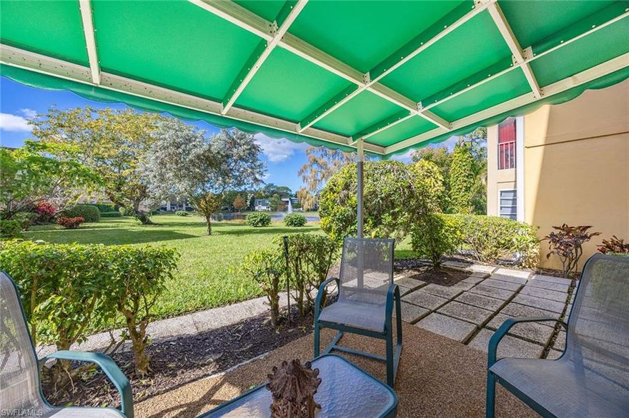 Welcome to this bright and meticulously maintained corner garden residence in the gated community of Naples Bath and Tennis. This rare offering is the only residence with a private outdoor area featuring a covered awning for exclusive enjoyment, offering peaceful views of the lake, mature trees and lush landscaping that define the community’s serene character.
This two-bedroom, two-bathroom first-floor residence comes partially furnished and features seamless entry, timeless tile flooring, custom built-ins and a kitchen with ample storage and a thoughtfully integrated built-in desk. The open-concept living area flows into a glass-wrapped dining space, while all windows and sliding doors have been updated with hurricane-impact glass for enhanced safety and energy efficiency. Included is one assigned parking space and abundant guest parking. Located in Flood Zone X500, outside high-risk flood areas, and remained untouched by recent storms. Larger pets welcome with approval. Minutes from the Gulf, shopping, dining and top-rated schools. Ideal for seasonal, full-time or investment use, subject to association guidelines.