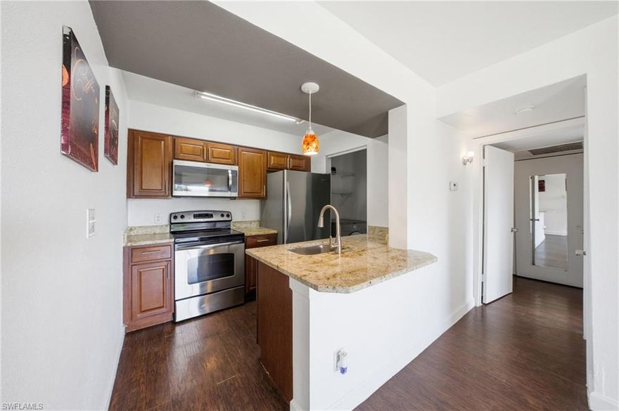 Experience Southwest Florida living and at an exceptional value in this 1+ Den and 1 bath condo in the heart of Ft Myers.  Welcome to Village creek, a great community just mere seconds away from Metro Parkway and all that town has to offer right at your disposal.  The community is amenity rich with an exercise room, clubhouse, basketball, and community pool.  This 3rd floor retreat offers you high and dry landscaped views from your balcony, gorgeous wood-like laminate flooring and tile throughout, and laundry in residence.  The kitchen is generously sized with stainless steel appliances, granite counters, and plentiful storage space to excite your inner chef.  Hosting a gathering will be a breeze with your large living area, den, and seamless flow to the balcony. Your primary bedroom comes equipped with TONS of closet and storage space, vanity, shower/tub combo, and plentiful natural light. The balcony enjoys lovely views and additional storage outside for beach toys or the like.  With one assigned parking space and ample guest parking, you are set!  Be sure to put this on your list for showings!