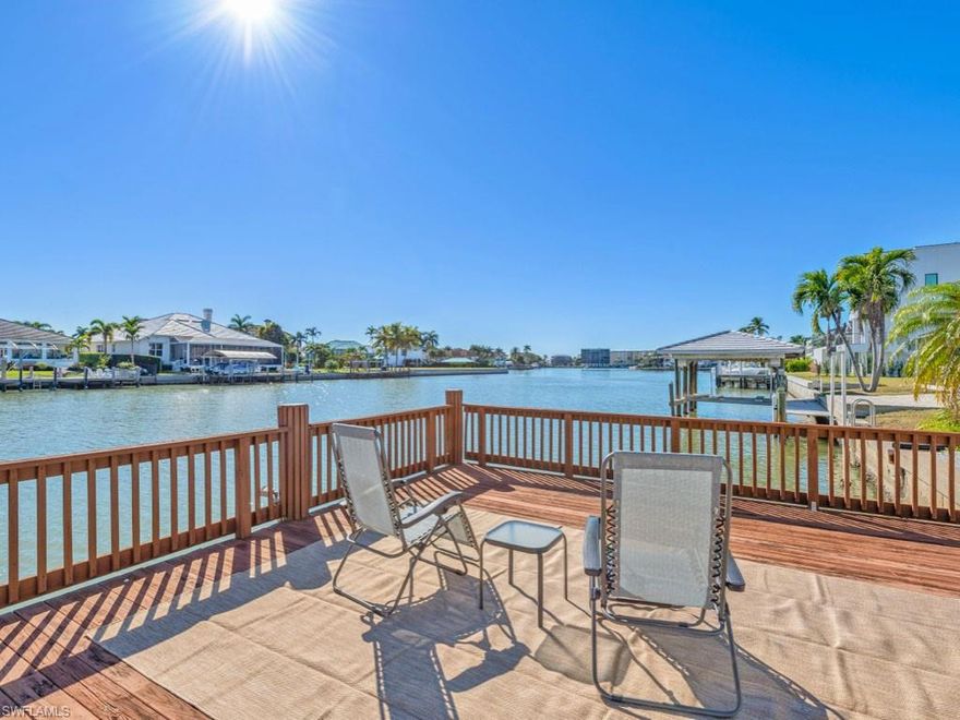 This home truly checks all the boxes! Set on a triple-wide canal with direct southern exposure and expansive west views from the dock with lift, this elevated home in Conners/Vanderbilt Beach offers exceptional waterfront living at a compelling value.
A gorgeous remodeled white kitchen flows into the living room, family room, and dining room. Bright, white interior and an open, airy floor plan with soaring ceilings and disappearing sliders create a true waterfront vibe. The primary suite features sliders to the screened pool and lanai, walk in closet, and a new spa-like bath with  separate shower and freestanding tub. Wake up every morning to water views! Two additional bedrooms—one with sliders to the pool—plus a full bath with access to the pool and lanai complete the living space.
Separate laundry room, two-car garage, new A/C, and a six-year-old roof.  Effective year built on tax record is 2005 due to new piping and major improvements. Bike to the beach, tennis, and pickleball. Close to Mercato, Whole Foods, and Trader Joe’s. Boat, fish, kayak, paddleboard, and enjoy waterfront living.