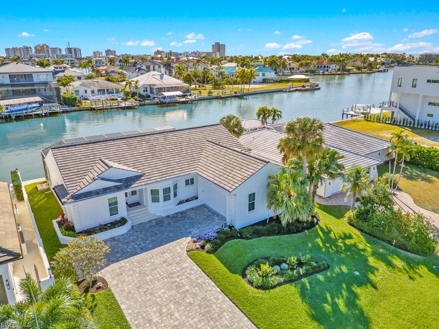 This home truly checks all the boxes! Set on a triple-wide canal with direct southern exposure and expansive west views from the dock with lift, this elevated home in Conners/Vanderbilt Beach offers exceptional waterfront living at a compelling value.
A gorgeous remodeled white kitchen flows into the living room, family room, and dining room. Bright, white interior and an open, airy floor plan with soaring ceilings and disappearing sliders create a true waterfront vibe. The primary suite features sliders to the screened pool and lanai, walk in closet, and a new spa-like bath with a separate shower and freestanding tub. Wake up every morning to water views! Two additional bedrooms—one with sliders to the pool—plus a full bath with access to the pool and lanai complete the living space.
Additional features include a separate laundry room, two-car garage, new A/C, and a six-year-old roof, to name a few. Bike to the beach, tennis, and pickleball, and enjoy close proximity to Mercato, Whole Foods, and Trader Joe’s. Boat, fish, kayak, paddleboard, and enjoy waterfront living.