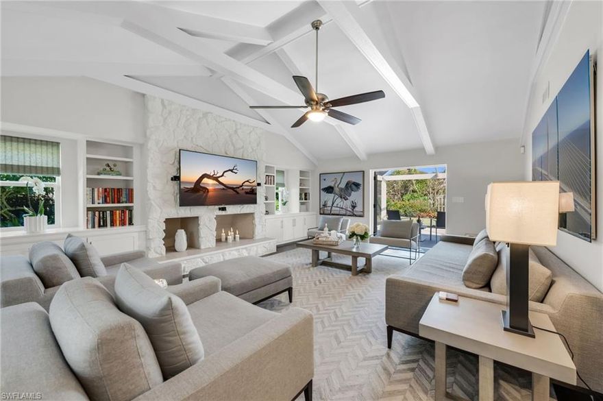 This lush, lovely .41 acre X500 lot, stayed HIGH AND DRY DURING HURRICANE IAN. Completely renovated with impact doors/windows and offered turnkey with quality furnishings, this exceptional 3 Bedroom+Den, 2.5 Bath residence is move-in ready and ideally located in Coquina Sands, one of Naples’ most sought-after coastal neighborhoods in the heart of Naples. Just two blocks from the Gulf of Mexico and Lowdermilk Park and three blocks from the new Four Seasons Naples Beach Resort and Spa, this home delivers premier Southwest Florida living.
Thoughtfully redesigned, the interior features a vaulted living room with exposed beams and an inviting stone fireplace that creates warmth and architectural character. The gourmet kitchen is equipped with top-of-the-line stainless steel appliances, coffee bar, wine cooler, oversized island with seating for eight, and abundant storage.
Outdoor living is equally impressive, offering multiple spaces for relaxation and entertaining, including a covered patio with smart shutter pergola, and a separate screened lanai, pool area, and expansive yard. The lush, professionally landscaped grounds showcase mature fruit trees, including avocado, lemon, lime, grapefruit, star fruit, banana, olive, fig, and peach. Additional highlights include impact-resistant windows and doors, and roof replaced in 2021.
Located just minutes from fine dining, boutique shopping, and the entertainment of 5th Avenue and 3rd Street South, this property presents an outstanding opportunity as a full-time residence, seasonal retreat, or investment property.