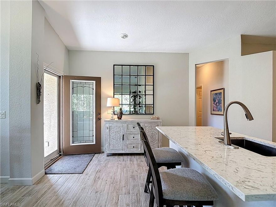 Welcome to Herons Glen Golf & Country Club, a sought-after resident-owned community offering resort-style living in a warm, active setting. With only 26 villas in this area, opportunities to own here are rare. This charming Preserve End-Unit Villa offers 1,100 sq. ft. of living space with 2 bedrooms and a desirable open, airy feel.

Step inside through a decorative etched glass front door and immediately notice the high ceilings and abundance of natural light that make this home feel bright and inviting. The updated kitchen features dropped-down quartz countertops, stainless steel appliances, and a functional layout perfect for everyday living and entertaining.

Enjoy easy maintenance with tile plank flooring throughout—no carpet anywhere. The primary suite includes a custom closet system and double sinks in the en-suite bath for added convenience.

The 2-car garage is a standout feature with built-in cabinetry and pull-down attic stairs, offering plenty of additional storage space. Add to that a garage Skeeter Beater" Screen to provide privacy but allow those warm breezes to flow through. Out back, relax in privacy of your screened lanai as the home backs up to the preserve, giving you a peaceful natural setting while still being just a short distance to all of the community’s main amenities.

Additional upgrades include a new roof and exterior paint (2021). This home is being offered turnkey with beautiful furnishings, with the exception of the primary bedroom set—making it easy to move right in and start enjoying the Florida lifestyle.

Residents enjoy an incredible array of amenities, including an 18-hole championship golf course ranked among Florida’s best by GolfNow, tennis, pickleball, bocce, shuffleboard, a fitness center with on-site physical therapy, and a resort-style pool with water aerobics and fitness classes. Social opportunities abound with crafts, ceramics, painting, quilting, book clubs, mahjong, bridge, billiards, yoga, tai chi, and more. The newly remodeled clubhouse, featuring a restaurant, sports bar, and grand ballroom, serves as the heart of this vibrant community.

Experience the perfect blend of luxury, activity, and community—this is resort-style living you may never want to leave.