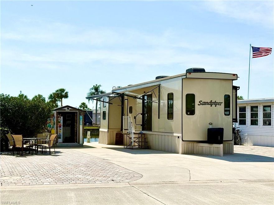 Welcome to 564 Cattleya Refuge in the Imperial Wilderness Condominium Association of Naples, Florida! This 2019 (2Br/1.5Ba) unit, located on the water and situated on LAND that YOU OWN, is being sold furnished. It is brilliantly maintained, features stainless steel appliances, and an atmospheric electric fireplace. The main bedroom contains a queen-size bed, washer & dryer, and generous closet space. The second bedroom offers another queen-size bed, full-size sofa bed, and a drop-down twin bed. The half bath is located off of the second bedroom and the full bath is located near the main bedroom. Outside, you will truly appreciate the relaxing vibe created by patio pavers, a rear grassy yard, lovely water view, and canopy from the RV. Storage space is certainly not a worry since the sale also includes a roomy storage shed. Imperial Wilderness Condominium Association is a location where you own the land when you purchase your home. It is not leased land or a Co-Op. Making this opportunity even more attractive, IWCA was never flooded or adversely affected by any recent hurricane. Plus the location is brilliant. It is approximately 3 miles to shopping and restaurants, 11 miles to the Naples beaches, and 8 miles to the Marco Island beaches. Airport access is easily attainable— a 45-minute drive (RSW). Maximizing the opportunity to affordably own in Naples, FL, the HOA fee of $898. per quarter is exceptionally reasonable. That fee covers many of your needs: the safety of a gated community, water, sewer, lawn care, basic cable, trash, recycling, and community amenities. Community amenities include 2 pools with spas, bocce, pickleball, pétanque, tennis, shuffleboard, billiards, ping pong, a library, clubhouse, 2 dog parks (1 pet, 40lb. max.), nature trail, and an extremely active events calendar— there are over 100 activities available per week! If you are looking for fun or a chance to relax in paradise, this is for you!