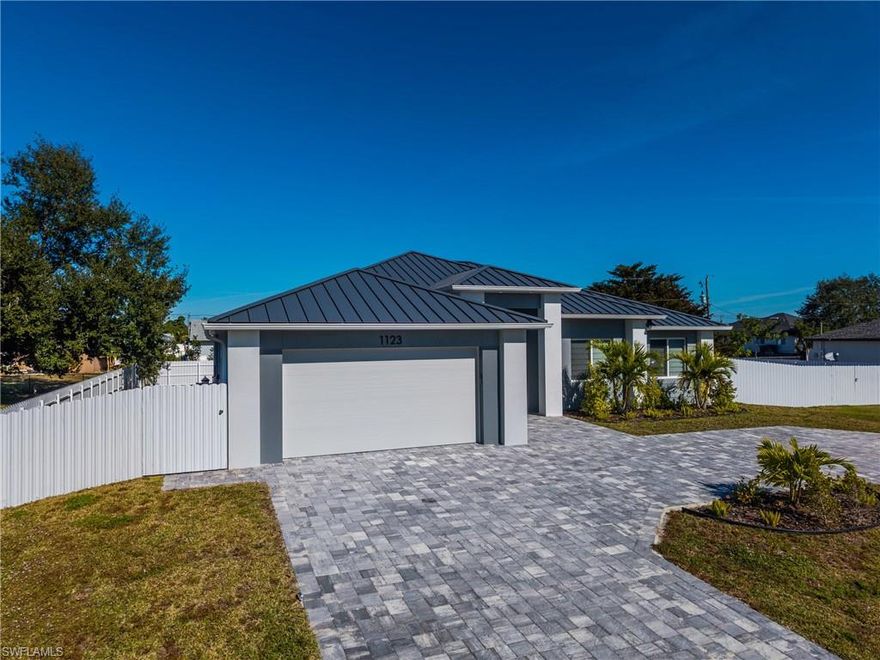 Welcome to this exceptional move-in-ready new construction home offering 4 bedrooms, 3 full bathrooms, and over 2,200 square feet of thoughtfully designed living space. High tray ceilings and an open-concept floor plan create a bright, spacious feel ideal for both everyday living and entertaining. This home features two primary suites, each with a private bathroom, providing flexibility for multi-generational living or guests. The kitchen flows seamlessly into the main living and dining areas, enhancing functionality and connection throughout the home. Step outside to your private backyard retreat complete with a large pool, outdoor shower, and a fully fenced oversized yard. An outdoor kitchen is currently being added, further elevating the home’s outdoor living and entertainment appeal. Additional highlights include a durable metal roof, hurricane-impact doors and windows, modern finishes throughout, and a circular driveway offering ample parking. Situated on a rare triple lot with no HOA, this property provides added space and privacy while remaining conveniently located near shopping, dining, and everyday amenities. Move-in ready and available now — schedule your private showing today.