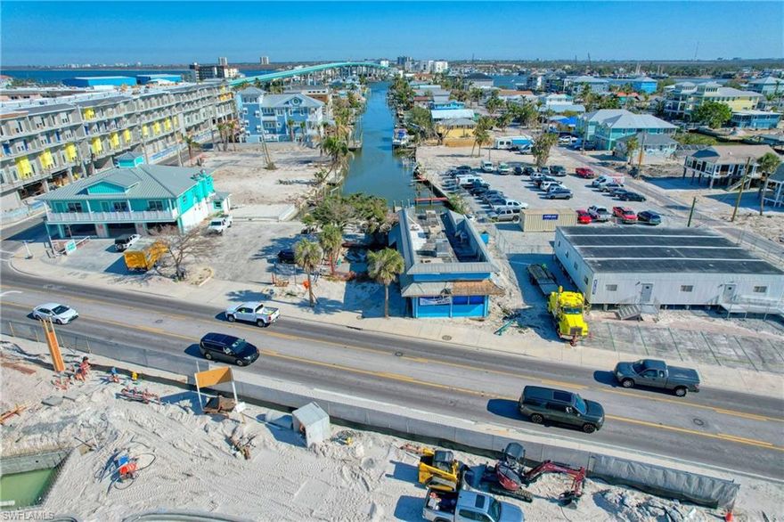 Be a part of the rebuild on Fort Myers Beach.  Endless possibilities with this waterfront location.  LIQUOR LICENSE available is a 4COP.  Property is located in the downtown zoning area, across from the Margaritaville Resort.  This parcel offers approximately 100' of water frontage with docks and direct access.  Property has sustained damage from Hurrican Ian.  Must sign hold harmless.