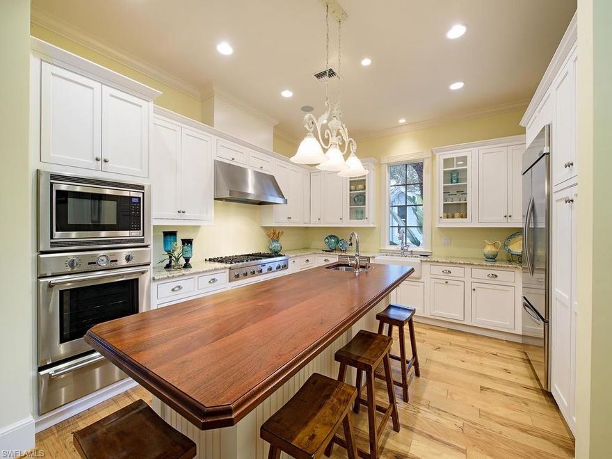 “Beachy Keen” is an IDEAL oasis perched above Gordon Drive in the heart of Olde Naples literally steps to shopping & dining on Third Street S! 2 short blocks to beach! Shows absolutely BEAUTIFULLY in person! Circular brick drive & steps welcome you into a sunny, 2 story entry with unique architecture, tall ceilings, warm wood floors, impact windows & french doors! Foresite-built, 1-owner home maintained well & used sparingly: lives like a much newer home! Open, flowing floorplan makes entertaining easy. Custom kitchen, family room flooded with  light, & separate dining room. Private VIP guest suite accessed right off the kitchen! Downstairs den/study with full bath close by too. Opposite, is the generous master and master bath fit for a couple: 2 vanities, claw foot tub, rainforest shower, dressing table, 2 WCs, and 2 BIG closets. Upstairs? Cozy den for guests, plus 2 large guest suites, each w. own bath. Balcony accessible from both for sunning & reading a great book: offers a peek at the shops on 14th! Outside? Enjoy poolside picnics! Gas grill, fireplace, & wet bar area spill onto a bi-level natural stone patio w.heated pool & spa. Even a fully fenced grassy area ideal for pets!