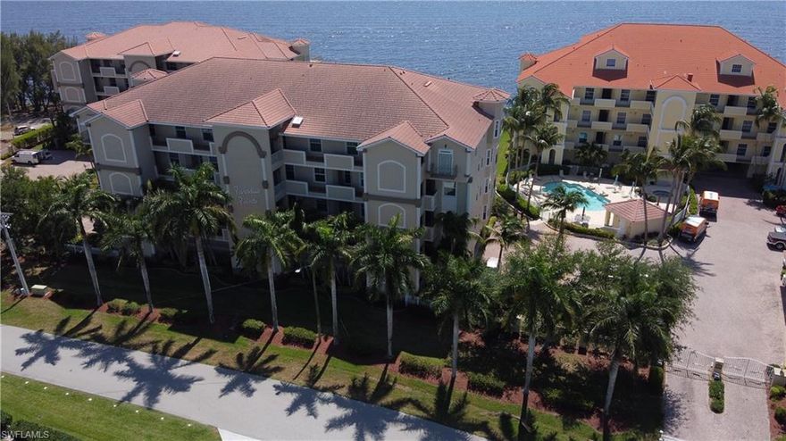 Welcome to Paradise! Situated on the Western Shoreline of the Caloosahatchee River. Watch the river roll by or catch a spirit-lifting sunrise from your oversized waterfront lanai. Resort-like living in this friendly, small, gated community with two heated large pools, jacuzzi, soothing fountains, outdoor kitchen area, and the adjoining expanse of Jaycee Park. Inside, soaring 9’6” ceilings and the open floorplan give a sense of spaciousness throughout the 3 BR/3BA, all ensuite, condo. The better-quality furnishings and a complete set of kitchen gear transfer with this turnkey opportunity. Heavy duty hurricane shutters provide protection and shade, allowing “lock-and-leave” with no worries. Dedicated laundry room; reserved inside parking space; 9x9 storage room; built-in closets; new vinyl plank floors. Live the good life.