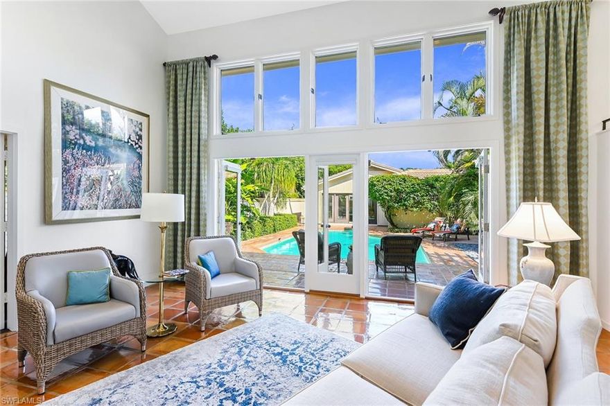 Welcome to your own private oasis, boasting .46 acres of peace and quiet inside the exclusive Pelican Woods neighborhood of Pelican Bay. As you walk through the entry gate, you are met by an expansive courtyard and sun-sparkling pool — making this home the ideal retreat for relaxing or lively entertaining. Perfectly designed for Florida living, this 5-bedroom, 4.5-bath home offers open flowing rooms and light streaming from soaring ceilings, dramatic windows and glass doors, providing access to the lush, beautiful grounds from every room. Built in 1980 and impeccably maintained, the main home has generous living spaces and an oversized owner's suite as the perfect retreat. Family and guests will enjoy resort-like accommodations while using the spacious Cabana built in 2016, offering independent living. A 3-car garage with electric charger and enclosed side yard for your dog provides all the practical benefits for modern living. Amenity-rich Pelican Bay offers private beach clubs with dining, tennis, golf and world-class fitness. Ideally situated in walking distance to Artis—Naples, Waterside Shops and white sand beaches of the Gulf. Your perfect Naples destination awaits.