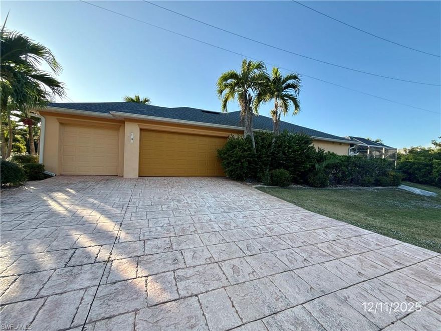 This 3-bedroom + Den, 2-bathroom POOL home is located in Cape Coral, FL and offers 2,220 square feet of living area. The open-concept floor plan includes three bedrooms, two full bathrooms, and a separate office/den. The main living area features accordion-style sliding glass doors that provide access to the screened pool area. The primary bedroom and one guest bedroom include sliding doors leading to the pool enclosure. The guest bathroom also has direct access to the pool area. The outdoor space includes a screened-in swimming pool with an in-ground spa and an outdoor kitchen area. Built in 2004, the property includes a three-car garage. Recent updates include a 2025 shingle ROOF, new light fixtures, and new ceiling fans. The home is located on El Dorado Parkway, across from the Cape Harbour area.