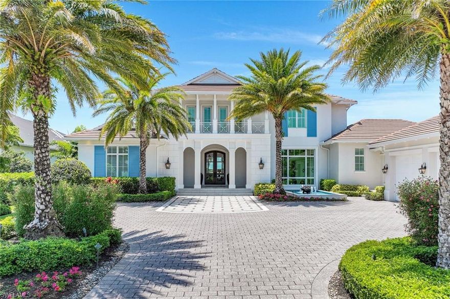 Located on a premier beachfront lot in the award-winning Miromar Lakes Beach & Golf Club, this exceptional estate was thoughtfully designed for those who appreciate food, wine, entertaining, and time spent with family. Blending Key West charm with refined coastal luxury, the open-concept floor plan welcomes you with a grand great room, gourmet chef’s kitchen, butler’s pantry, private den/office, and an upstairs secondary living area.

A connoisseur’s dream, the impressive 800-bottle walk-in wine cellar leads to a remarkable 1,100 sq. ft. multi-function game and media room. Designed for ultimate enjoyment, this expansive space includes multiple TVs, distributed video system, gorgeous full bar, billiards table, game table, and dedicated home theater area. Sliding doors allow effortless indoor-outdoor living, opening to the oversized lanai and resort-style pool and spa.

The outdoor living space is an entertainer’s paradise with a full summer kitchen, Evo grill, and imported Italian wood-burning pizza oven—perfect for gatherings of all sizes. The luxurious primary suite serves as a private retreat, offering a spa-inspired bath, outdoor shower with marble waterfall feature, two generous walk-in closets, and a peaceful outdoor seating area. Three additional oversized guest suites, each with its own beautifully appointed en-suite bath, ensure comfort and privacy for family and friends.

Experience exceptional lakefront living just steps to Miromar’s signature white-sand beach, world-class amenities, dining, boating, tennis, pickleball, and championship golf—where every day feels like a getaway.
