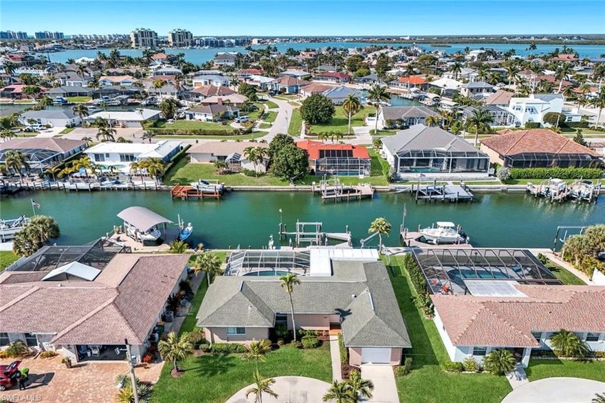 Discover this charming and impeccably maintained 2-bedroom, 2-bathroom waterfront home on picturesque Marco Island. Well kept by the same meticulous owners since 1998, this delightful residence offers an enviable combination of coastal living and modern convenience.

As you enter, you'll be captivated by the cozy and sunlit interiors that offer a warm and inviting ambiance.  It offers wonderful natural light throughout. The home includes a formal dining room, thoughtfully enhanced with a Murphy bed, transforming it effortlessly into a comfortable third sleeping area for guests.

The property boasts a concrete pool, perfectly positioned to take advantage of its northwest-facing orientation, ensuring ample sunlight throughout the day. Whether you're lounging by the pool or enjoying an evening swim, you'll relish in the serene waterfront views.

Boating enthusiasts will appreciate the deeded dock equipped with a 13,000 lb lift, making it easy to set sail on the Gulf of Mexico, which is just a breezy 15-minute boat ride away. Additionally, the location is ideal for quick and convenient island access, allowing you to explore all the joys Marco Island has to offer, including the nearby restaurants, shops, and Resident's Beach, where beachfront relaxation is just minutes away by car.

This home is not just a property; it's a lifestyle opportunity. Enjoy the best of waterfront living with the convenience of location and the comfort of a lovingly maintained home. Come and experience your perfect coastal retreat!
