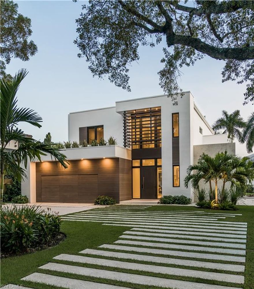 Premier Old Naples location, this newly built modern home is three blocks from the beach.  Located on one of only avenues lined with majestic mahogany trees; located one block north of Central Avenue which means 100% single-family zoning.  Open floor plan with spacious living area that opens directly to the pool deck. The sun illuminates the house with southern exposure, breathtaking living area with high ceilings, formal dining and open kitchen from Italy with top-of-the-line Miele & Liebherr appliances, wine cooler and built in coffee machine.  The private master suite on the upper floor offers an outdoor shower, open shower and free-standing bathtub.  Two further bedrooms upstairs and one downstairs each with designer ensuite bathrooms. Enjoy the beautiful gas-heated pool and spa with water features, sun shelf with water beds and multicolor LED lights for evening ambiance.  Entertain yourself outdoors in the multimedia equipped outdoor lounge and summer kitchen with a built-in gas Grill, refrigerator. electric roll-down screens, fire place and fire pit.