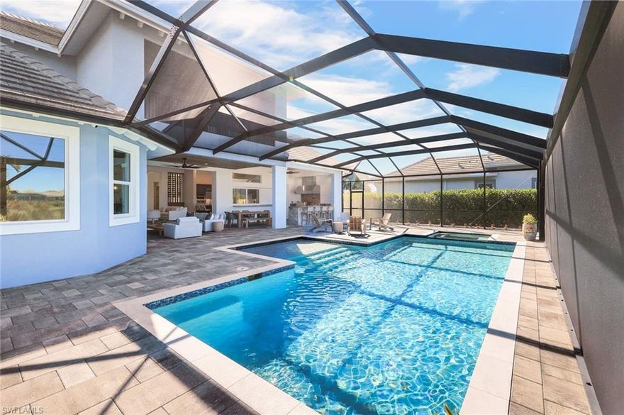 Welcome to an extraordinary luxury estate that embodies elegance, grandeur and timeless sophistication. A rare opportunity to own one of the most distinguished two-story residences in a highly sought-after section of the prestigious Isles of Collier Preserve community. Gracefully situated on a sprawling, elegantly landscaped half-acre home site on a tranquil Cypress natural waterway, this magnificent residence boasts 4,284 sq ft of partially furnished and impeccably designed living space. The home features two refined bedrooms on the ground floor, including the master suite, and two second floor bedrooms. An executive office, a formal dining room with French doors, a spacious loft, seven beautifully appointed bathrooms and two attached garages for three cars complete this luxurious abode.
Every detail was meticulously curated for discerning homeowners who value architectural excellence and serene, organic luxury. The grand, light-filled interior boasts soaring ceilings adorned with exquisite crown molding, complemented by rich wood flooring and bespoke architectural artistry throughout. Elegant light fixtures enhance the natural light, creating a harmonious blend of elegance and tranquility.
The gourmet kitchen is designed for the discerning chef. It boasts striking quartz countertops, a large center island, premium stainless-steel appliances, an induction cooktop, wall oven, two beverage drawers, sliding windows leading to the outdoor kitchen and a generously sized walk-in pantry with a built-in desk and cabinets. This kitchen elevates both daily living and sophisticated entertaining.
The first floor Owner’s Retreat is a haven of comfort and beauty. This exquisite space features custom ceiling details and serene pool and river vistas. Experience Spa inspired luxury with dual vanities, twin showers, and two outstanding custom walk-in closets equipped with floor-to-ceiling built-ins for organization and indulgence.
Ten-foot sliding glass doors effortlessly blend the interior with the large outdoor living oasis. The breathtaking western-facing lanai boasts panoramic screening, allowing you to relish unparalleled sunsets. A rich cypress wood ceiling, resort-style saltwater pool and spa with mood lighting, and a cabana bath complete the luxurious outdoor experience. The outdoor granite kitchen, equipped with gas and infrared premium appliances, a bartending station, refrigerator and ice machine provides an ideal setting for both intimate gatherings and grand celebrations.
Features include impact-rated glass, a whole-home Sonos sound system, security cameras, climate-controlled single garage, a fireproof built-in safe, programmable multi-color landscape lighting and a mosquito system for outdoor comfort.
This estate epitomizes luxurious waterfront living, where timeless design meets modern, organic sophistication in one of Naples’ most sought-after gated communities, offering quick access to beautiful beaches and Downtown restaurants and shops.