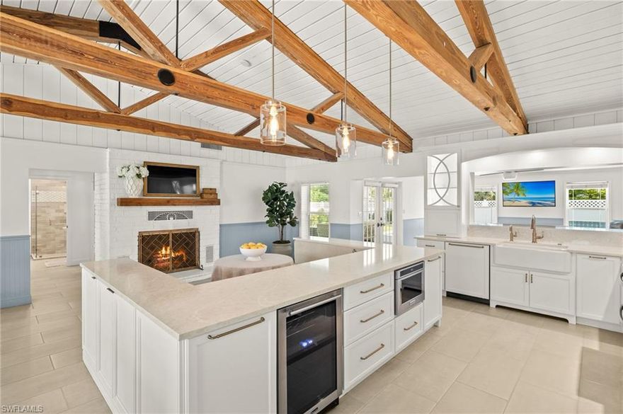 Stunning remodel. Designer details. Ultimate location. Enter a residence where timeless charm meets high-design living—this completely reimagined three-bedroom, three-bath beauty in Fort Myers desirable McGregor Corridor is nothing short of extraordinary. Following a complete renovation, this home is a masterclass in craftsmanship, luxury and thoughtful reconfiguration. Every inch has been meticulously upgraded—walls moved, ceilings raised and features elevated—to create a living experience that is relaxed and refined. Inside, you'll be captivated by vaulted ceilings in the great room and primary suite, featuring hand-harvested cypress beams from the local Cypress Slough and crisp white tongue-and-groove wood paneling. Natural textures meet elegant design with beadboard and chair rail wainscoting throughout, a wood-burning fireplace and custom finishes. The gourmet kitchen is a showstopper, quartz countertops with full-height backsplash, a custom banquet, ZLine refrigerator with filtered water and even a left-in reverse osmosis system. The adjacent laundry room—newly added inside for convenience—makes everyday living effortless. The luxury continues outdoors with a new pool by Coastal Custom Pools, complete with marble pavers, a sun shelf with bubblers, a water feature wall and a freestanding hot tub for evening relaxation. Entertain with ease or unwind in style within your fenced-in backyard and dedicated dog run. A replaced front porch with pavers sets the tone before you even step through the door. No detail was overlooked, solid core interior doors, new impact windows, new roof, gutters, trim, tile flooring, upgraded door hardware and whole-home ADT security. There’s even a 50-amp RV plug, generator hookup, irrigation system and whole-house water softener for seamless living. The primary suite is an elegant sanctuary with navy shaker cabinets, quartz counters, Kohler Purist fixtures, custom closets, natural wood shelving and a walk-in shower with dual sinks. Each guest suite is a design lover’s dream featuring custom wallpaper, board and batten accents, built-ins and spa-inspired baths. In one of Fort Myers charming, family-friendly communities, you're a short distance from Triangle Park, the Caloosahatchee River, and all the culture, cuisine and entertainment of downtown. This is not just a remodel, it’s a home of heart and soul, curated for the way you want to live.