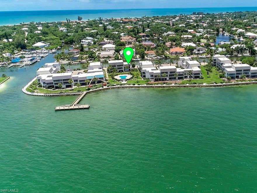 Mariner Pointe Townhouse - gut renovated with a coastal contemporary look and beautiful bay views! Ground-level living area with tile floors, new open kitchen with Cambria Quartz countertops, large living and dining area plus glassed-in lanai, and new powder bath. Great views! The second story has 2 bedrooms, a glassed lanai with Bay water views, 2 new bathrooms with custom cabinetry, and Cambria quartz countertops. New AC systems 2021, new electrical shades on the first floor and upper floor. Mariner Pointe offers 33 boat slips for owners, deeded beach access, 2 heated pools, 2 tennis courts, shuffle board, a paver parking lot, and easy on/off island access.