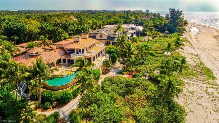 Privately poised on 200ft of Gold Coast beach frontage encompassing 2.37 acres at the very end of West Gulf Drive. Historically known as Woodmere Preserve, this compelling residence is a one of a kind offering with an aesthetically exceptional design and awe inspiring 180* views. Acquisition of the westerly adjacent parcel allowed for a substantial addition to the main house in 2010 which included the construction of the
raised pool area and steel framed cabana room featuring Cypress ceiling details and walls of glass. The grounds showcase exceptional plantings from around the globe balanced by bronze sculptures. Upon entry of the main house your eye is drawn to the azure waters of the gulf and the multiple living areas inside and out. The main house is comprised of three interior living areas, kitchen/dining along with the principal suite on
the top level, a guest suite, stunning pool area with spa and expansive decking. Two additional structures are attached by a covered breezeway.