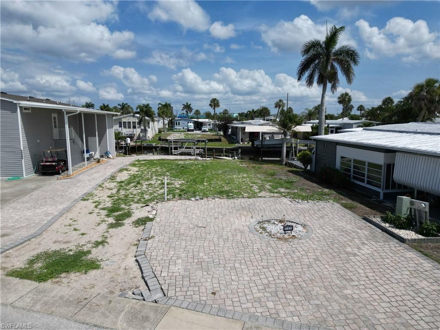 Many vacant lots that were available in Bayside Estates have already been purchased and will most likely be built upon in the coming months.  The inventory of vacant lots is running lower and lower as each lot transitions from available to sold.  Therefore, if you're looking to acquire a desirable Bayside lot, look no further.  This lot has been cleared and is patiently waiting for a new buyer to come along and put a new home on her.  The seawall is in good shape, there is an area along the seawall where the former owner left the excellent paver work.  The property comes with a very nice dock and boat lift, which if you were to price out how much it would cost to put in a new dock and boat lift, your talking a lot of $$$$.  This lot is on the salt water side of Bayside therefore your access to the gulf by boat is unobstructed.  Come and see it and lets put a deal together.   
Bayside Estates is the best kept secret of Fort Myers Beach. This incredibly active and friendly 55+ community is the crown jewel on the gulf coast. Bayside estates is only 2.5 miles to the beach and is accessible by either car or boat--right from either your driveway or private boat dock. A very popular activity is riding your electric bicycles to the beach for the day and visit the world-famous Jimmy Buffett’s Margaritaville. Just don't step on a pop-top!!. Nearly all of the major retail vendors are within a very short driving distance for ultimate convenience. For those who don’t know a lot about Bayside Estates, it is a very fun place to call home---some would even say it’s a mature person’s playground. Whether you want to play pickleball, tennis or bocce ball or hang out at the community pool, or simply cruise the hood in your golf cart, there is always something going on around here. People are friendly and you will be warmly welcomed.