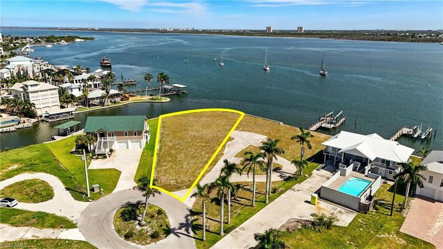 Estero Bay is every boaters dream location with endless water views on the exclusive North End of Fort Myers Beach. Here’s your opportunity to own one of the few remaining large parcels that can support a truly grand, private estate in this beautiful boater's community. Tucked away on a quiet cul de sac, this rare property offers the perfect blend of seclusion and proximity, with the connecting lot also available for sale (MLS#2025007080) —it's an ideal location for the ultimate waterfront compound. The adjoining 16,000 square foot parcel allows you to expand your footprint to nearly an acre of waterfront bliss, all with direct Gulf access, panoramic water views, and room to accommodate large yachts. This site offers everything the most discerning buyers seek—privacy, spectacular water views, and an unrivaled location just minutes from Times Square, Margaritaville, and the island’s top hotspots. The shoreline features 200 feet of protected seawall and intersecting canal frontage with the bonus exceptional deepwater access. Combining both lots would transform the property into an expansive waterfront retreat—perfect for hosting, relaxing, or simply enjoying the horizon from sunrise to sunset.The property is development ready with $350,000 design plans included by acclaimed architect Rich Guzman and styled by Adelyn Interiors. The plans showcase a sleek 6,075 sq. ft. estate with around 17,000 sq. ft. of outdoor living, including an elevated infinity pool, wrap around decks, and multiple outdoor lounges—blurring the line between indoors and out. Utilities are in place for a smooth start and every interior detail has been carefully curated for a flawless finish with the option to customize to your taste. This large site offers endless possibilities—add guest quarters, luxury amenities, or create a sprawling compound. With the ability to combine both parcels, you’re looking at a rare opportunity to build one of the most impressive estates on the island, fully tailored to your vision.  Whether you choose to build on one of the lots or both, your vision starts here.
