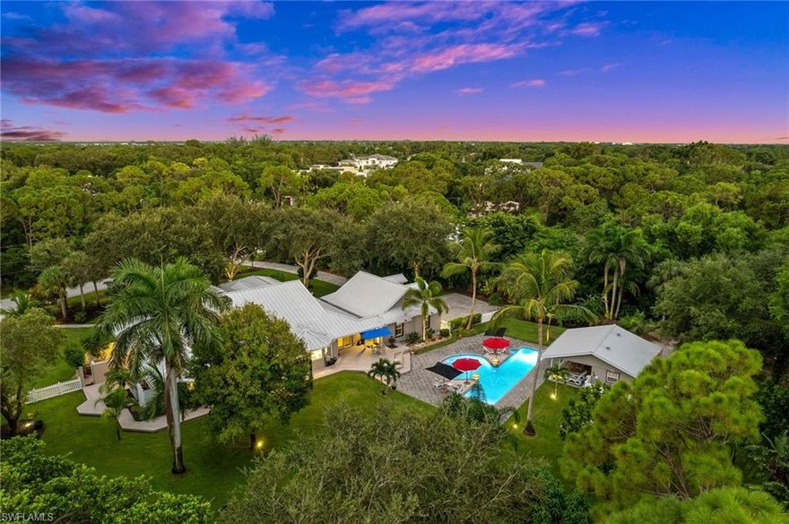 Nestled in the heart of Naples in the sought after location of Pine Ridge, this elegant and casually sophisticated home offers a move-in ready oasis with outdoor living at its best. Meticulously maintained and perfectly positioned on a sprawling, private lot of 1.33 acres, this home provides a park-like setting for unparalleled privacy, tranquility and a poolside escape. Step inside to discover a home designed for effortless luxury living. The interior features a newly renovated chefs kitchen and formal dining room that sets the stage for memorable gatherings. Bright and airy, the home offers an abundance of space and storage, allowing for a lifestyle of ease and organization. Unwind in the comfort of the private pool, surrounded by a deck and expansive pavered area that’s perfect for relaxation and entertaining all set within lushly landscaped grounds. The screened front porch, cabana with outdoor kitchen, and retractable pergola with motorized screens provide additional spaces for leisure and relaxation. This home also features storm protection, newer metal roof, a generous 3+ car custom garage and completely fenced back yard. Located just moments from beautiful Naples beaches and upscale shopping and dining at Waterside shops, this property offers an unmatched SWFL lifestyle. Embrace the allure of this property and experience the epitome of Naples living where every detail has been thoughtfully crafted to create a home that exudes elegance and relaxation.