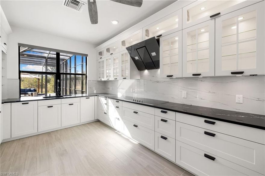 Introducing this custom, reimagined, & extraordinary “Heatherton” estate pool home, showcasing 4,332 sq.ft. of designer-upgraded living space, thoughtfully crafted for both luxury and functionality. This residence offers 5 bedrooms with 5 full bathrooms, an upstairs loft, and a dramatic $40k glass-paneled catwalk & staircase, this home delivers something unique & special! The heart of the home is the fully reimagined, chef-inspired kitchen, featuring sleek black quartz countertops, custom white shaker cabinetry with glass-front uppers, and a striking modern black range hood as the focal point. An extended wall of built-in cabinetry provides exceptional storage, while two large picture windows flood the space with natural light and create a true indoor-outdoor connection that is perfect for passing drinks, food, or hosting al fresco gatherings. A massive custom walk-in pantry offers impressive storage capacity and includes a dedicated secondary refrigerator. Contemporary tile flooring, under-cabinet lighting, and clean modern lines complete this showpiece kitchen. The two-story family room captures panoramic views of the outdoor oasis, including one of the home’s most coveted upgrades: an extended 25-ft lanai, which is a feature many homeowners wish they had added. The newly finished travertine lanai, resort-style pool with waterfall, and peaceful preserve backdrop set the tone for relaxation, entertaining, and unforgettable Southwest Florida sunsets, thanks to the property’s highly desirable western exposure. The first floor also includes a private guest bedroom and full pool bath. Upstairs, the luxurious owner’s suite offers a separate sitting room, two walk-in closets, dual vanities, a soaking tub, and an oversized walk-in shower. All secondary bedrooms feature walk-in closets and easy access to full baths, providing comfort and privacy for family and guests. The expansive living area provides endless possibilities and the open layout makes it easy to tailor the home to your lifestyle. Nestled inside The Place at Corkscrew, residents enjoy an unmatched resort lifestyle: a zero-entry pool with two dramatic waterfalls and a 100' waterslide, poolside food & drink service, indoor/outdoor dining, café, two-story fitness center, child care center, pickleball, tennis, volleyball, basketball, dog park, and more.
Welcome to luxury, comfort, and lifestyle all in one incredible home.