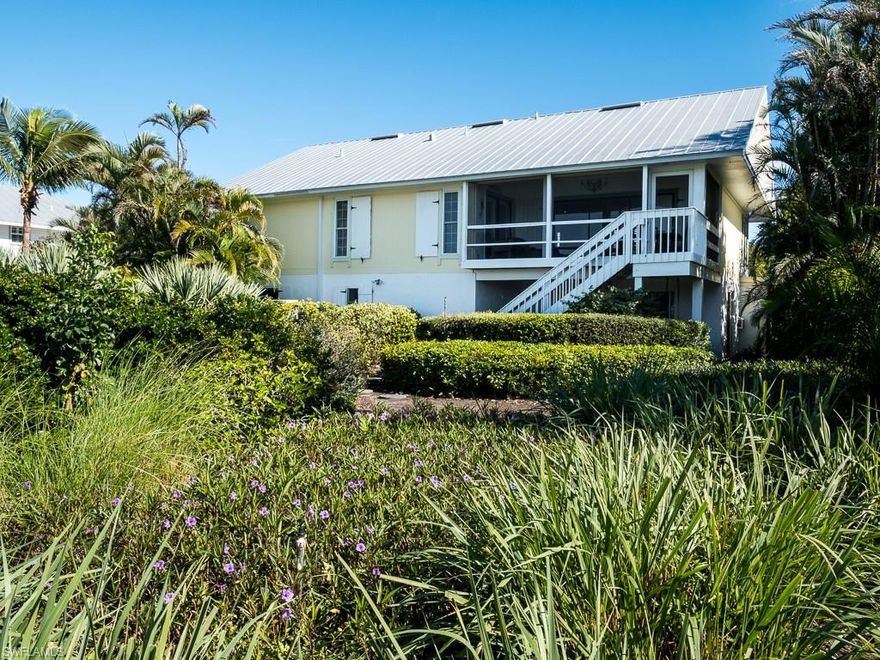 This tropical treasure elevated ranch style home is surrounded by native plants & trees creating a wonder of bursting colors. Whimsical & cheerful describe the feel of this 3 bedroom, 2 bath piling home in the Dunes Golf & Tennis Community. From the beach-themed wall mural to the expert use of interior colors this home is an island paradise. Kitchen features granite counters, tile back splash, natural light & stainless steel appliances. Living room features a soaring cathedral ceiling, & sliders that open to the screened lanai w/ amazing views of the lake & golf course beyond. Private office off the dining room surrounded completely by natural vegetation, creates the perfect backdrop for a quiet hideaway.  Master suite w/ beautiful wood floors opens to the screened lanai & offers a relaxing bath w/ marble counter tops, glass bowl sink & linen closet. Additional features include plantation shutters, double car garage, large workbench/storage area, expansive lower level & laundry room. Conveniently located near the causeway allowing for easy off-island access, the Dunes Golf and Tennis Club offers a semi-private golf course, pool, tennis, clubhouse and an award winning restaurant.