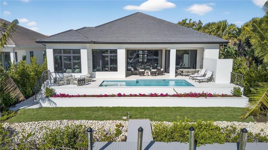 Experience refined coastal living in this newly completed, designer-finished and furnished canal-front residence offering coveted southern exposure, a private dock with direct Gulf access, and a premier walkable setting just moments from Naples Bay Resort, Bayfront, and world-famous 5th Avenue South, as well as Naples’ iconic white-sand beaches. Built to the latest 10-foot base flood elevation, this waterfront home reflects modern architecture, exceptional craftsmanship, and seamless indoor-outdoor living.

Offering 4 bedrooms plus a study and sitting area, 4.5 baths, and 3,617 square feet of light-filled interiors highlighted by a grand 12-foot foyer, wide-plank European white oak floors, architectural ceiling details, and tranquil water views. The chef’s kitchen features an oversized island with polished ocean-shore quartz and premium Thermador panel-ready appliances, opening effortlessly to a dramatic great room with cathedral ceiling and custom built-ins.

The primary suite is a serene waterfront retreat with dual custom wardrobes and a spa-inspired bath. Outdoor living is equally compelling, with nearly 450 square feet of covered space, a fully equipped outdoor kitchen, and an expansive pool deck with heated pool and spa. Additional highlights include smart home automation, integrated audio, pre-wired security, and a whole-house Generac generator.

An exceptional opportunity in one of Naples’ desirable waterfront settings.